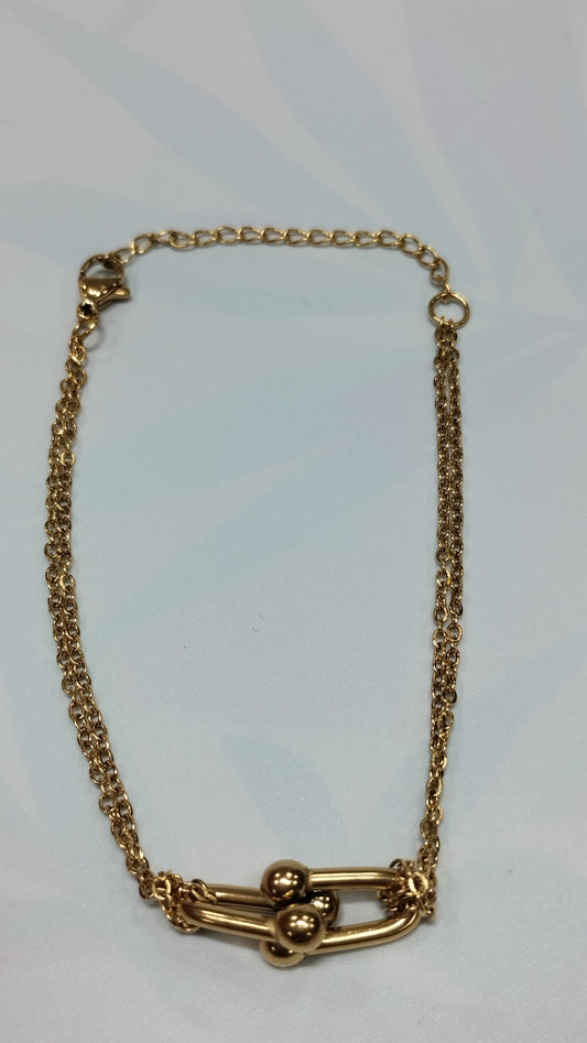 Pulcera de acero dorado